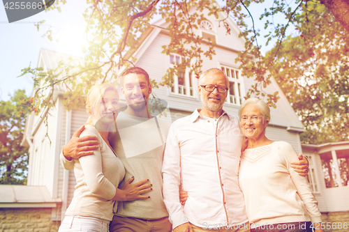 Image of happy family in front of house outdoors