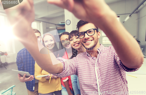 Image of creative business team taking selfie at office