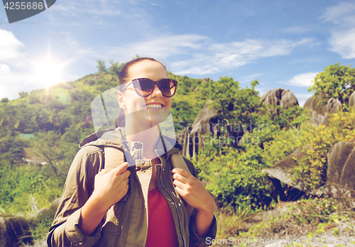 Image of happy young woman with backpack traveling