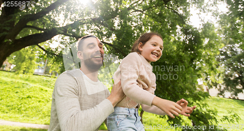 Image of happy family having fun in summer park