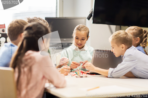 Image of happy children with laptop at robotics school