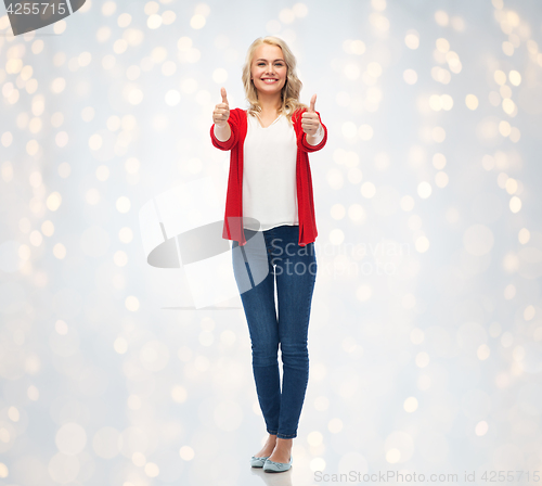 Image of happy smiling young woman showing thumbs up