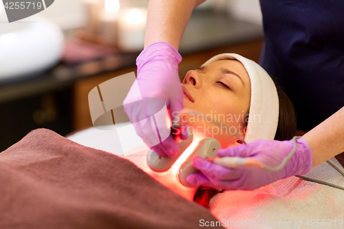 Image of young woman having face microdermabrasion at spa