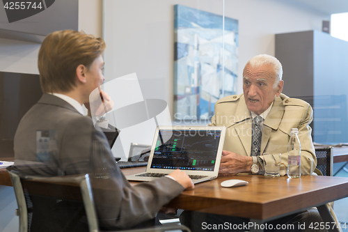 Image of Financial advisor consulting senior client with his investment strategy.