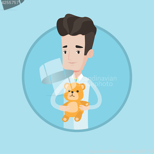 Image of Pediatrician doctor holding teddy bear.