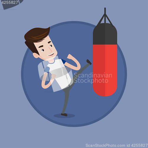 Image of Man exercising with punching bag.