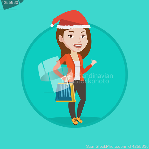 Image of Woman in santa hat shopping for christmas gifts.