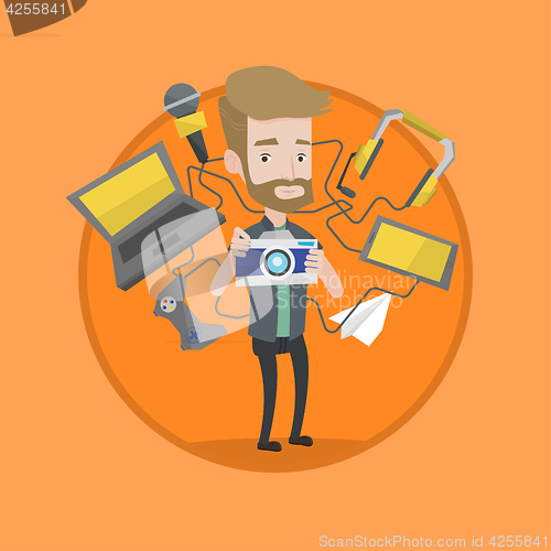 Image of Young man surrounded with his gadgets.