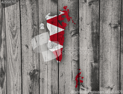 Image of Map and flag of Bahrain on weathered wood