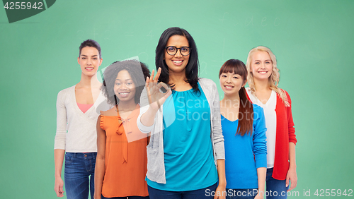 Image of international group of happy women showing ok