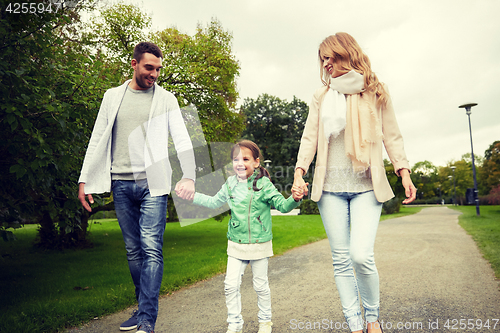 Image of happy family walking in summer park