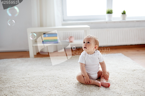 Image of happy baby with soap bubbles at home