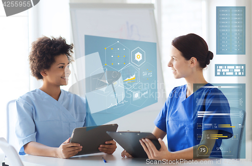 Image of doctors with tablet pc and clipboard at hospital