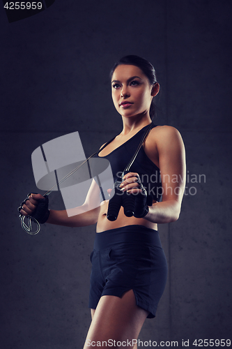 Image of young sporty woman with jumping rope