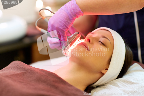 Image of young woman having face microdermabrasion at spa