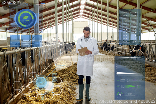 Image of veterinarian with cows in cowshed on dairy farm