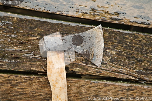 Image of Axe on wet planks