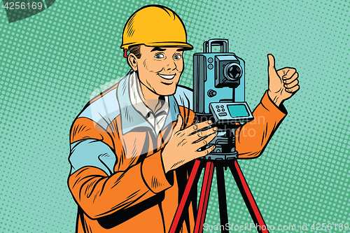 Image of Builder surveyor with a theodolite optical instrument for measur