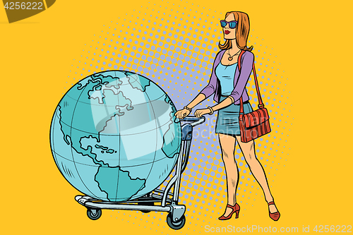 Image of Woman tourist with a Luggage cart with the planet Earth