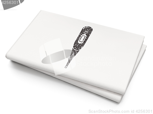 Image of Medicine concept: Thermometer on Blank Newspaper background