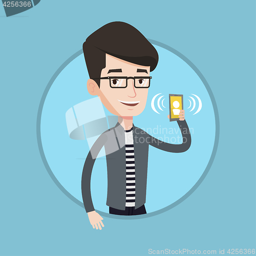 Image of Man holding ringing mobile phone.