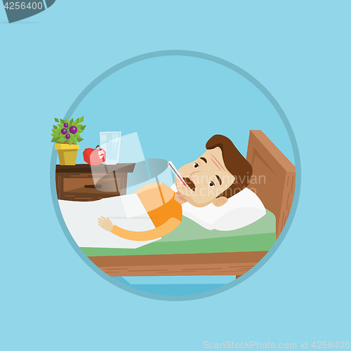 Image of Sick man with thermometer laying in bed.