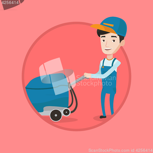 Image of Male worker cleaning store floor with machine.