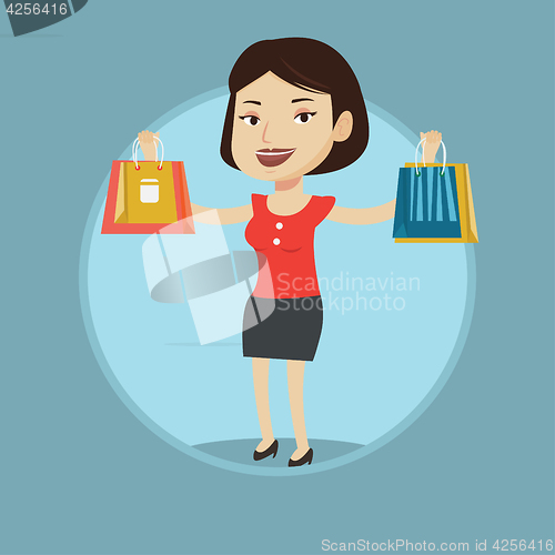 Image of Happy woman holding shopping bags.