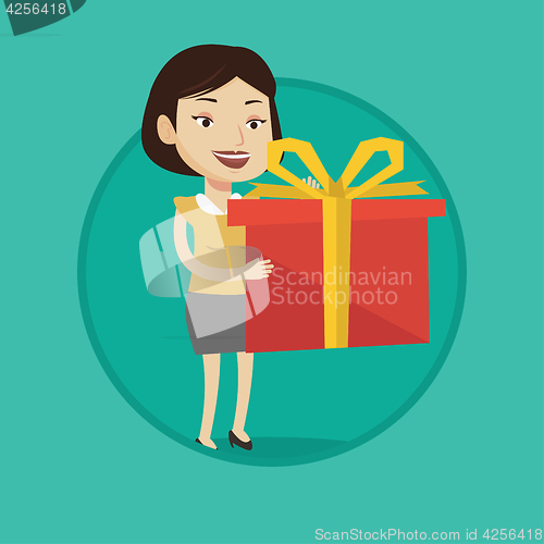 Image of Joyful caucasian woman holding box with gift.