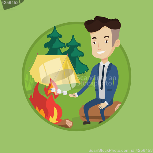 Image of Businessman roasting marshmallow over campfire.