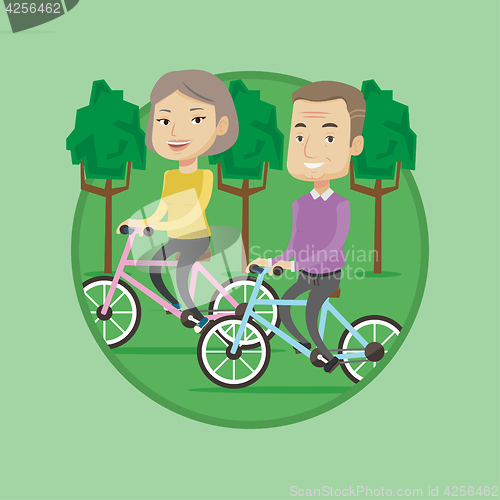 Image of Happy senior couple riding on bicycles in the park
