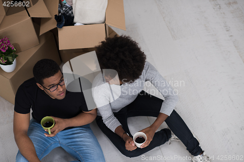 Image of African American couple relaxing in new house