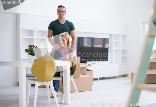 Image of Young couple moving in a new home