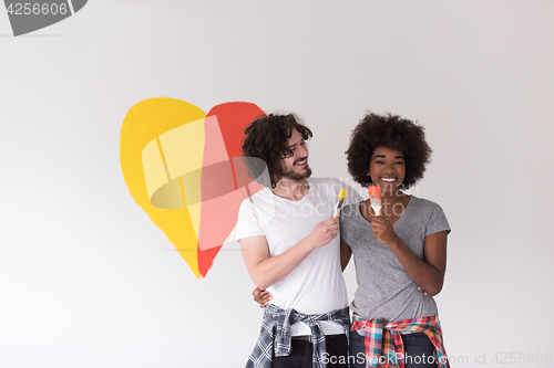 Image of couple with painted heart on wall