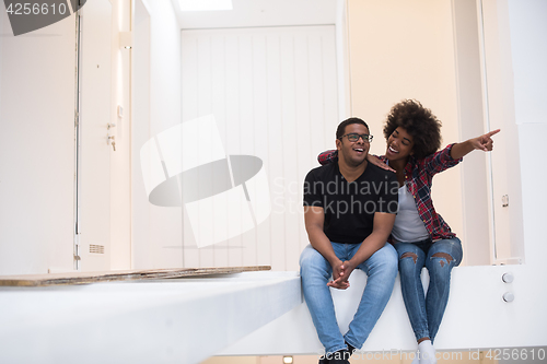 Image of couple having break during moving to new house