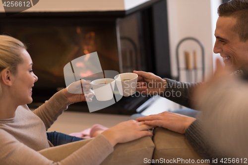 Image of Young couple  in front of fireplace