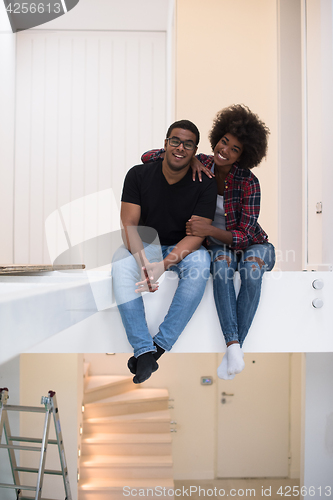 Image of couple having break during moving to new house