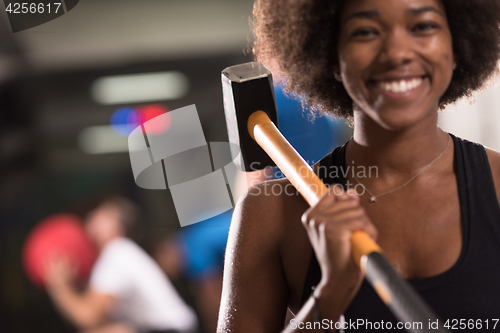 Image of black woman after workout with hammer