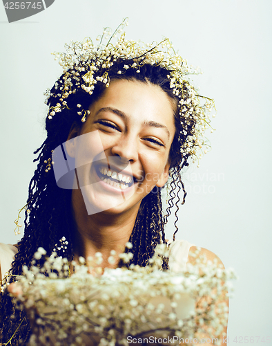 Image of young pretty brunette girl with bouquet of little white spring f