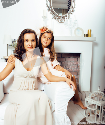Image of Portrait of smiling young mother and daughter at home, happy fam