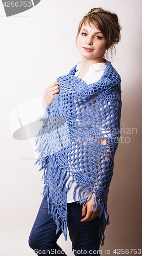 Image of pretty young blond real woman with wool wrap in studio on white 