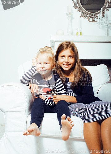 Image of two cute sisters at home interior playing, little happy smiling 