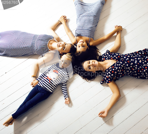 Image of Mature sisters twins at home with little daughter, happy family 