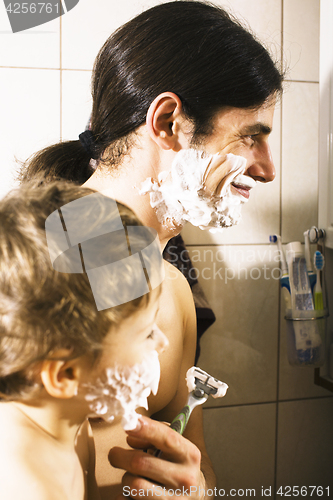 Image of Portrait of son and father enjoying while shaving together, lifestyle people concept, happy family closeup