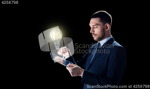 Image of businessman with tablet pc and lightbulb