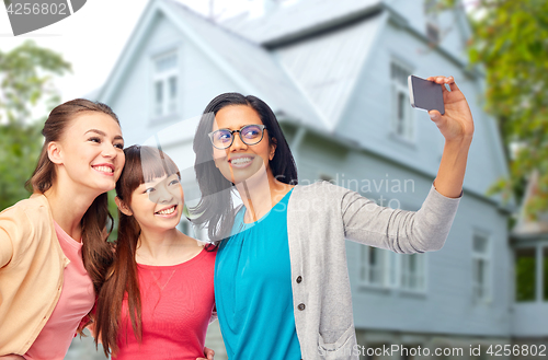 Image of international group of happy women taking selfie