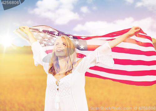 Image of happy woman with american flag on cereal field