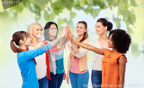 Image of international group of happy women doing high five
