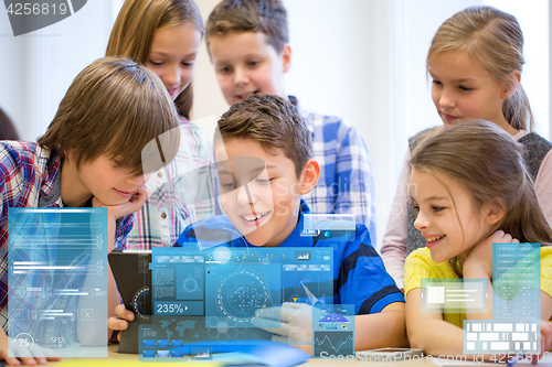 Image of group of school kids with tablet pc in classroom