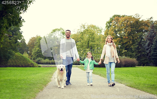 Image of happy family with labrador retriever dog in park